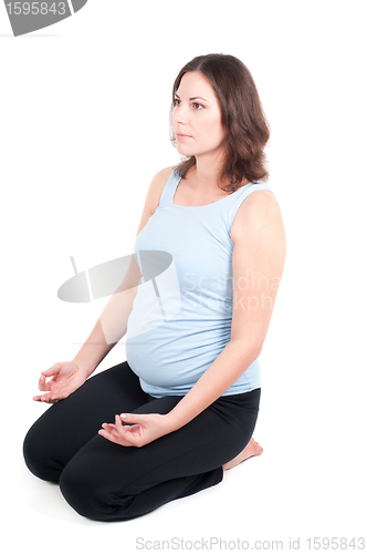 Image of Portrait of pretty pregnant woman practicing yoga