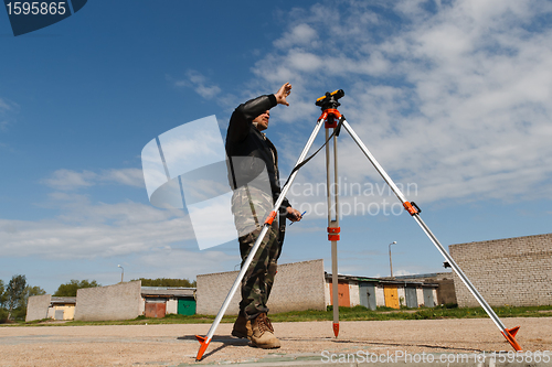 Image of Land surveyor on construction site