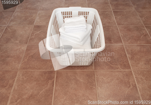 Image of Clean white towels in a laundry basket