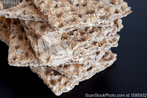 Image of Multi-grain crisp bread on dark background