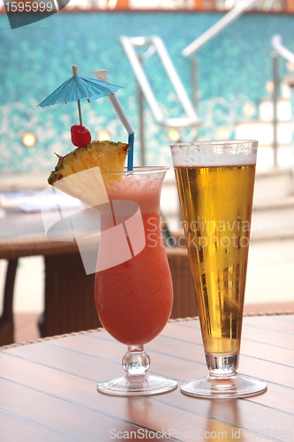 Image of glass of fruit cocktail and a glass of beer