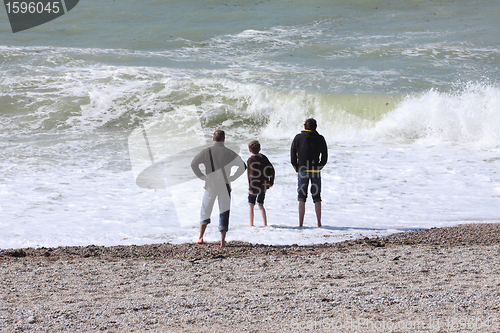 Image of a father and his two boys watching the sea