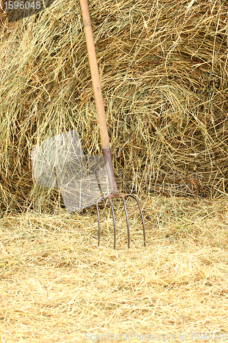 Image of pitchfork standing on a pile of straw