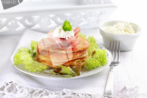 Image of Small potato pancakes with salad