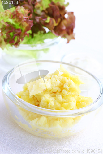 Image of Mashed potatoes in bowl with salad