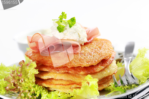 Image of Small potato pancakes with salad