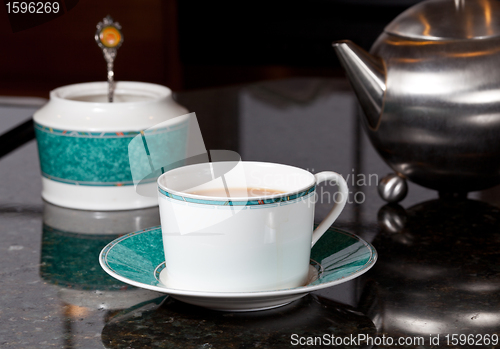 Image of Tea poured from stainless steel teapot