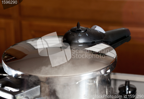 Image of Pressure being released from cooker on hob