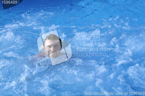 Image of man in jacuzzi of spa center 