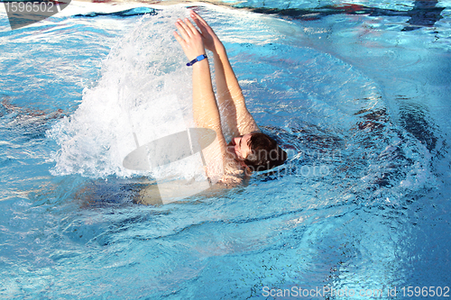 Image of young man learn swimming backstroke in pool