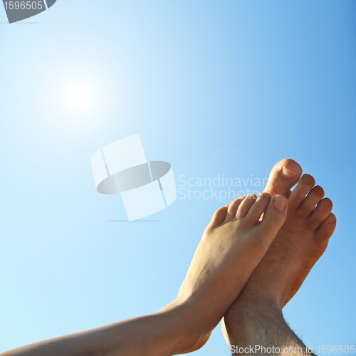 Image of male and female legs on summer background