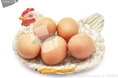 Image of Eggs on decorative hen nest