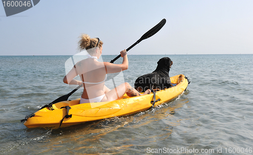 Image of woman and dog on a kayak