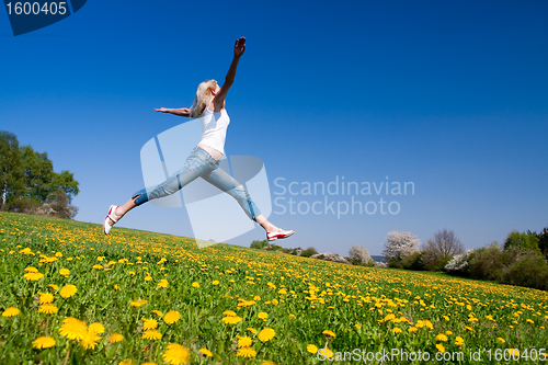 Image of happy young woman on meadow