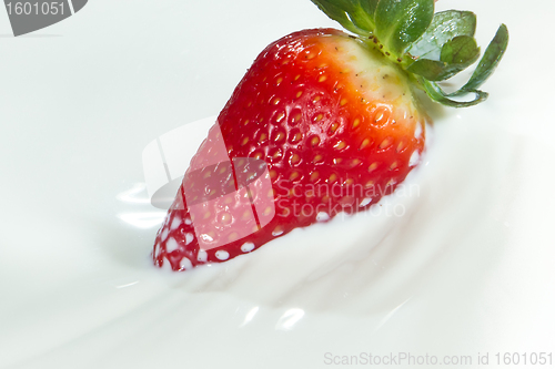 Image of strawberry splashing into milk