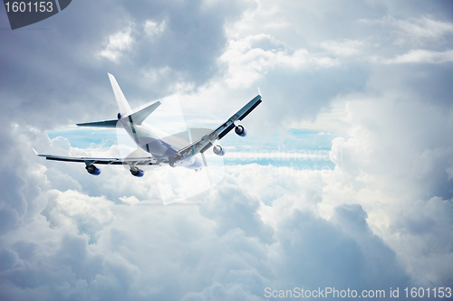 Image of Airliner flying through the thick clouds