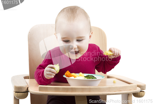 Image of young child eating in high chair
