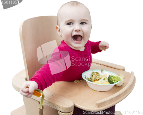 Image of young child eating in high chair