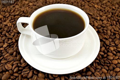 Image of Coffee in white cup on coffee beans