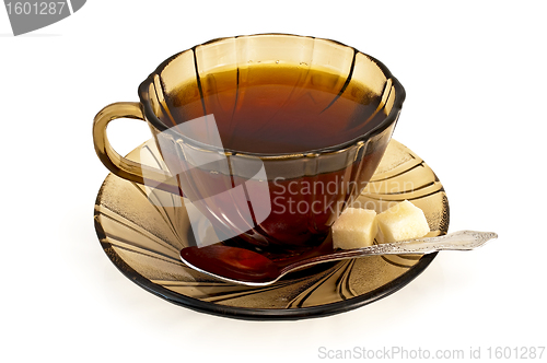 Image of Tea in a cup with a spoon of brown sugar and