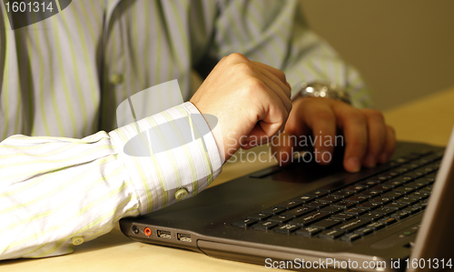 Image of Young man working on laptop