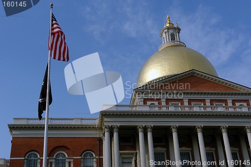 Image of American Flag with POW MIA in front of State House