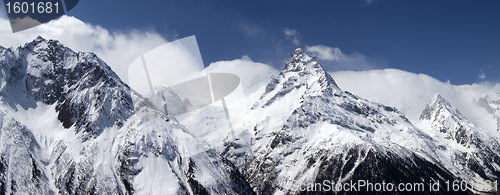 Image of Panorama mountains in clouds. View from the ski slope.