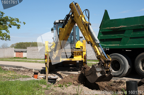 Image of excavator loaded dumper truck