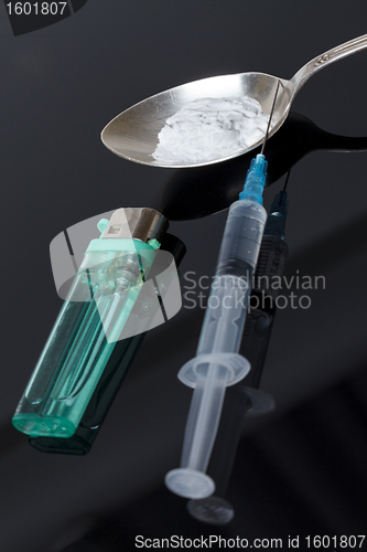 Image of Syringe, spoon, heroin and lighter