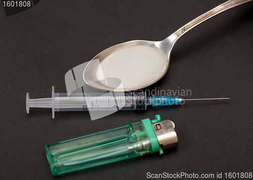 Image of Syringe, spoon, heroin and lighter