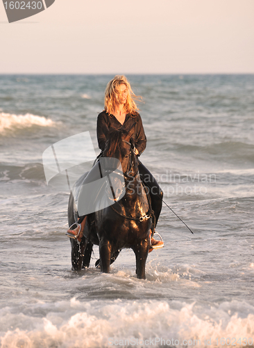 Image of riding woman in sea