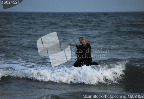 Image of riding woman in sea by night