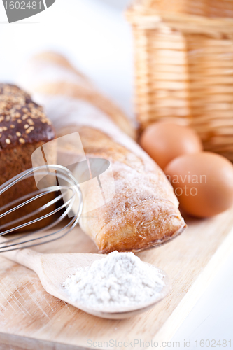Image of bread, flour, eggs and kitchen utensil