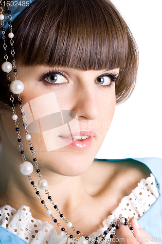 Image of woman in blue dress with pearl beads