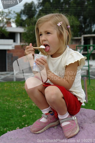 Image of the girl eats ice-cream