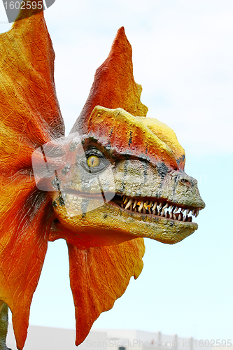 Image of Dilophosaurus dinosaur with orange collar