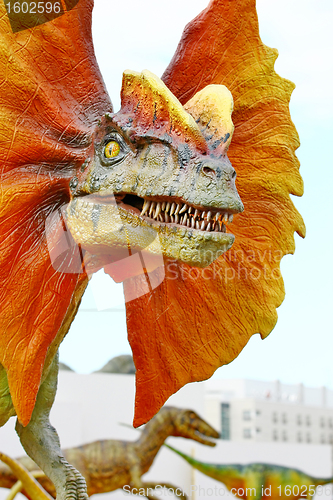 Image of Dilophosaurus dinosaur with orange collar