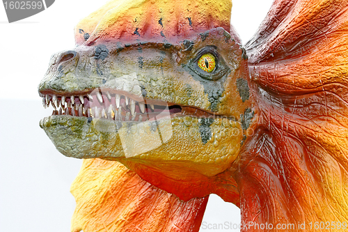 Image of Dilophosaurus dinosaur with orange collar