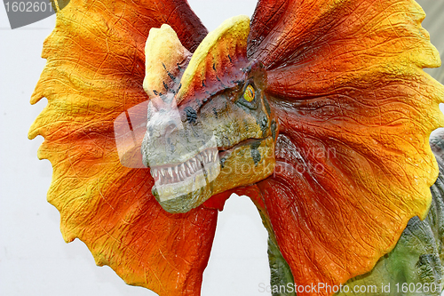 Image of Dilophosaurus dinosaur with orange collar