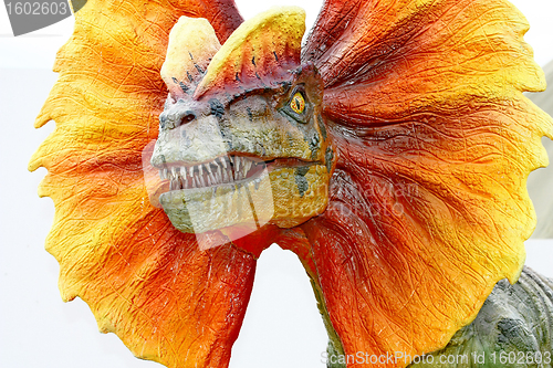 Image of Dilophosaurus dinosaur with orange collar