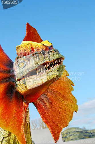 Image of Dilophosaurus dinosaur with orange collar