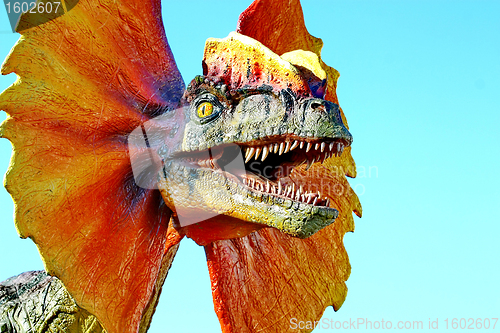 Image of Dilophosaurus dinosaur with orange collar