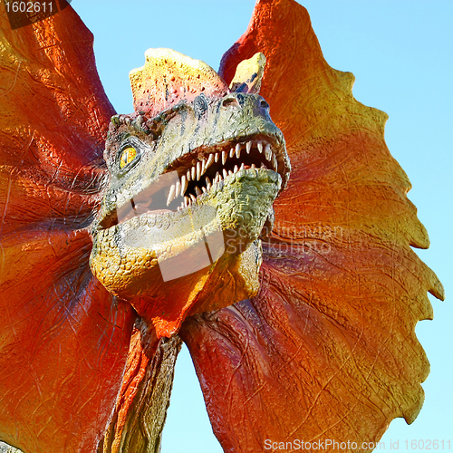 Image of Dilophosaurus dinosaur with orange collar