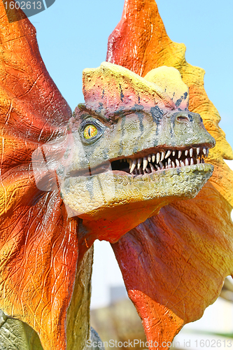 Image of Dilophosaurus dinosaur with orange collar