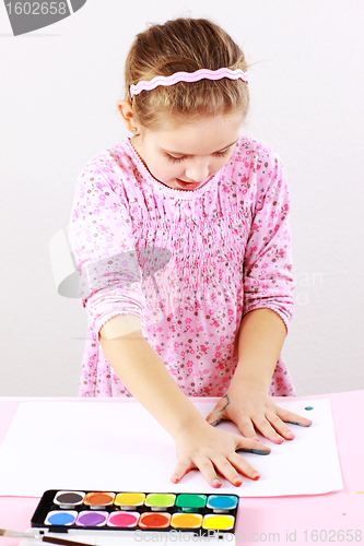 Image of Cute girl painting with watercolor