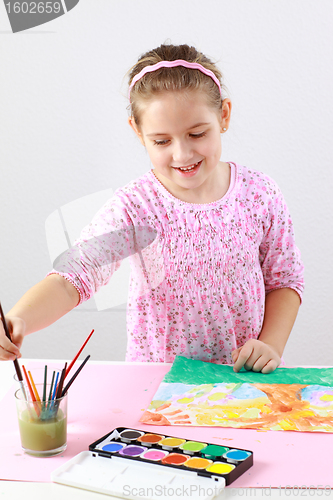 Image of Cute girl painting with watercolor