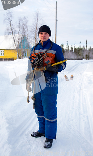 Image of The worker-electrician  in blue overalls 