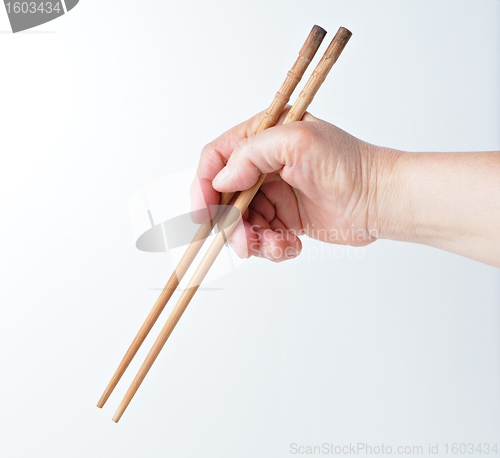 Image of hand using chopsticks