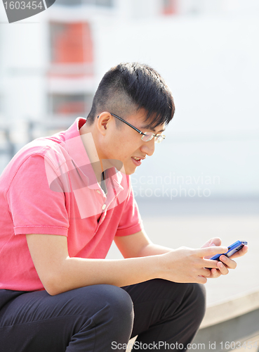 Image of Man typing message on phone