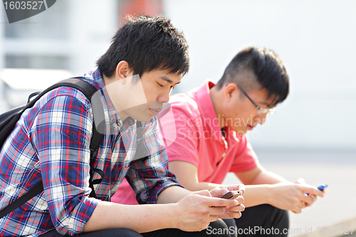 Image of young man looking on cellphone